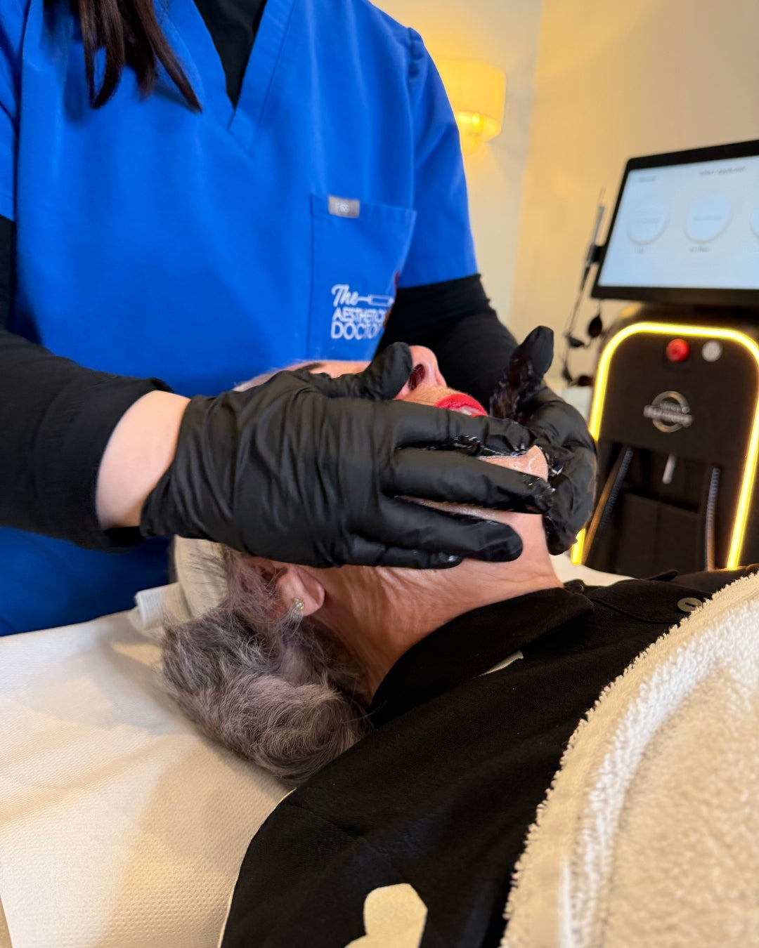 A skincare treatment in progress, applying a mask on a client