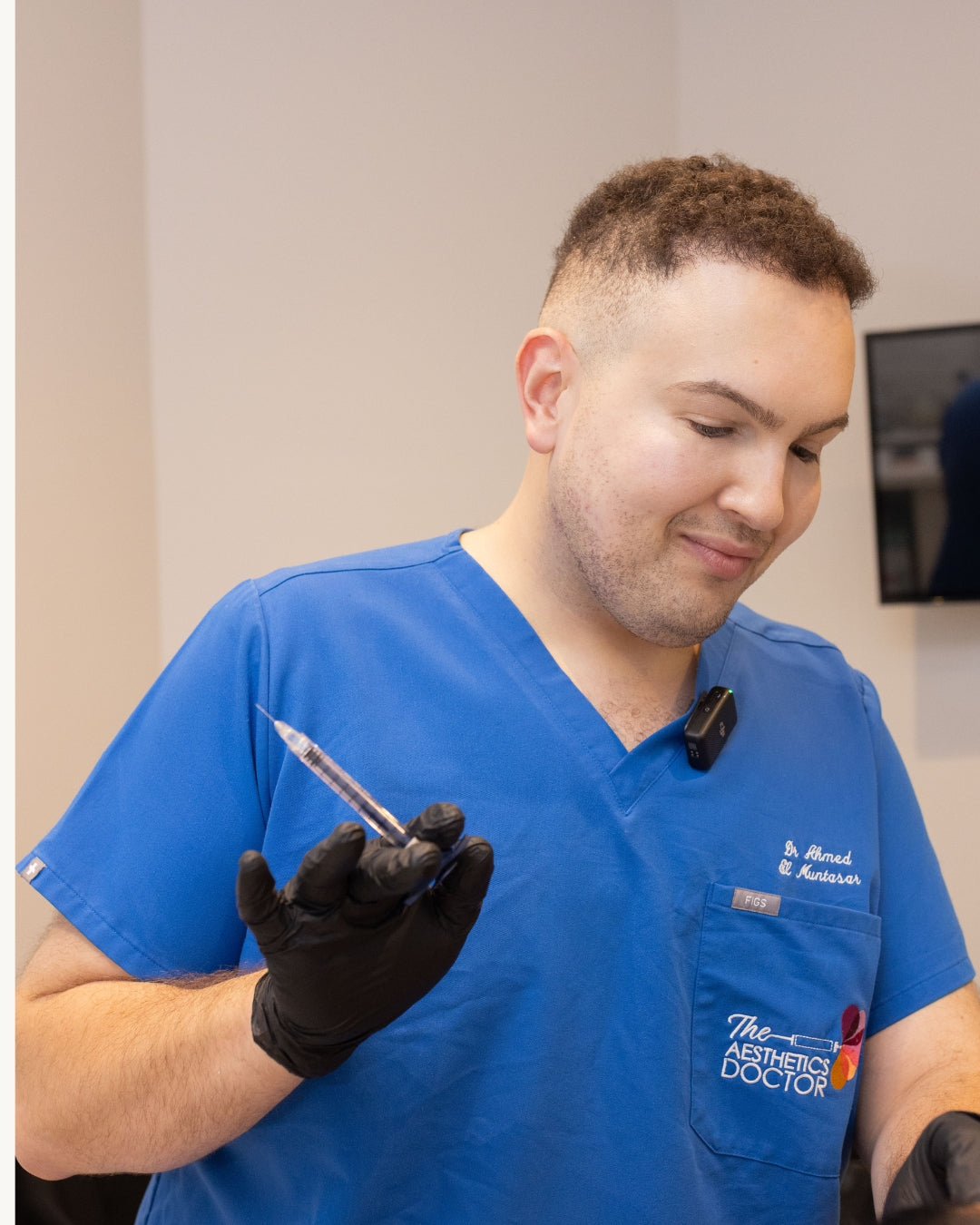 Dr Ahmed holding an injectable treatment