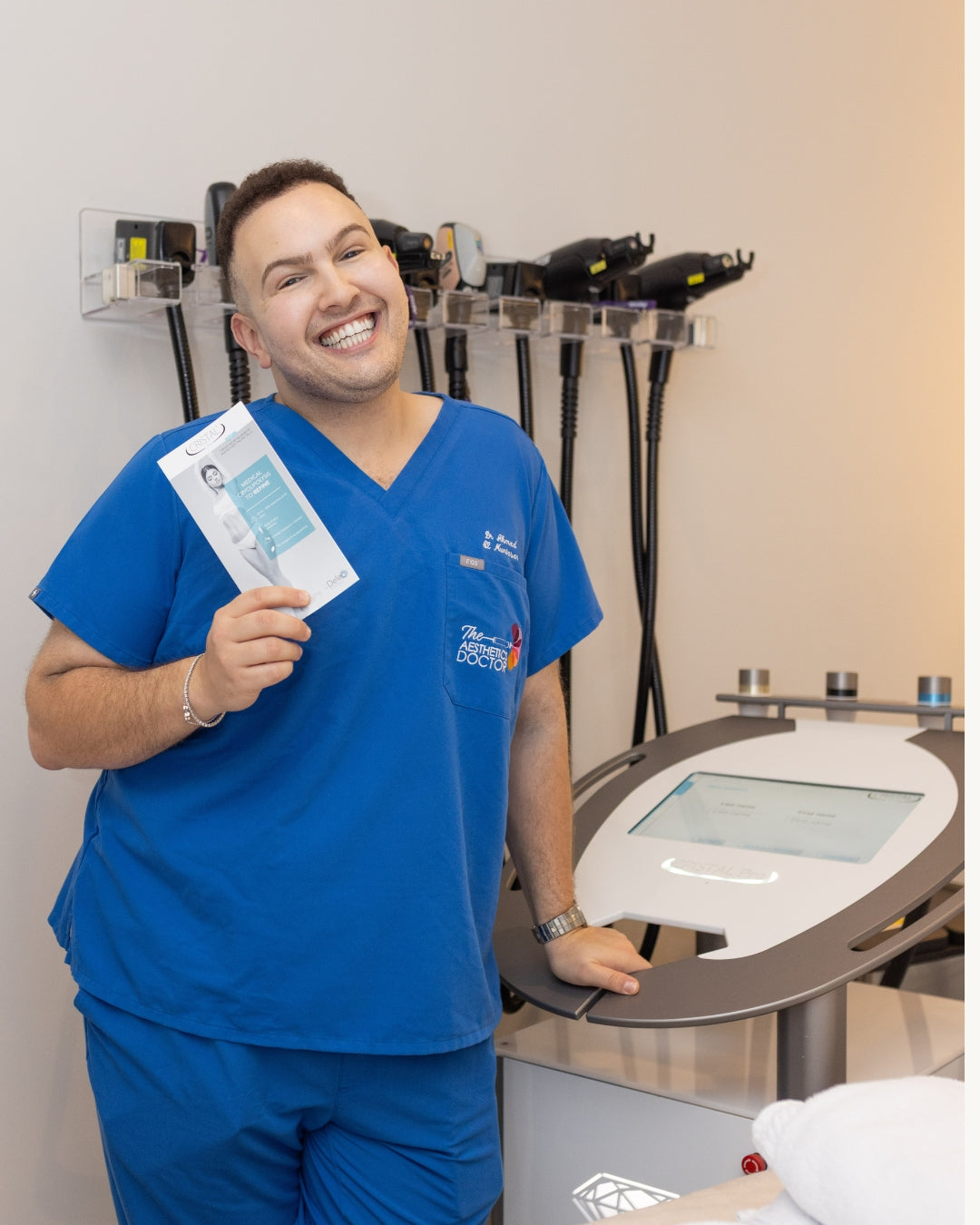 Dr Ahmed holding the fat dissolving machine