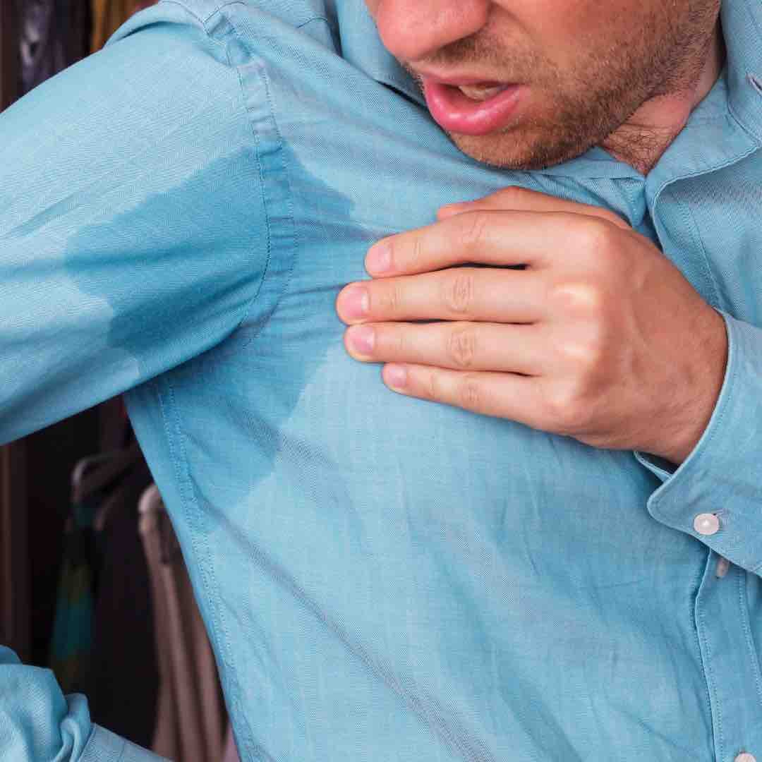 man sweating through shirt