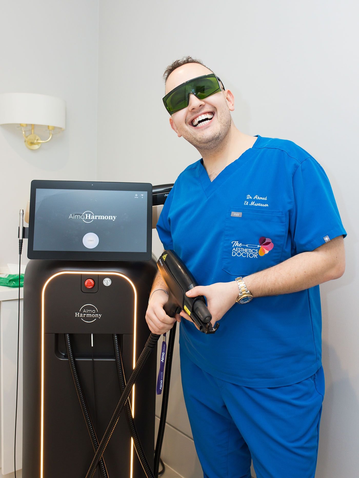 dr ahmed posing with alma harmony machine