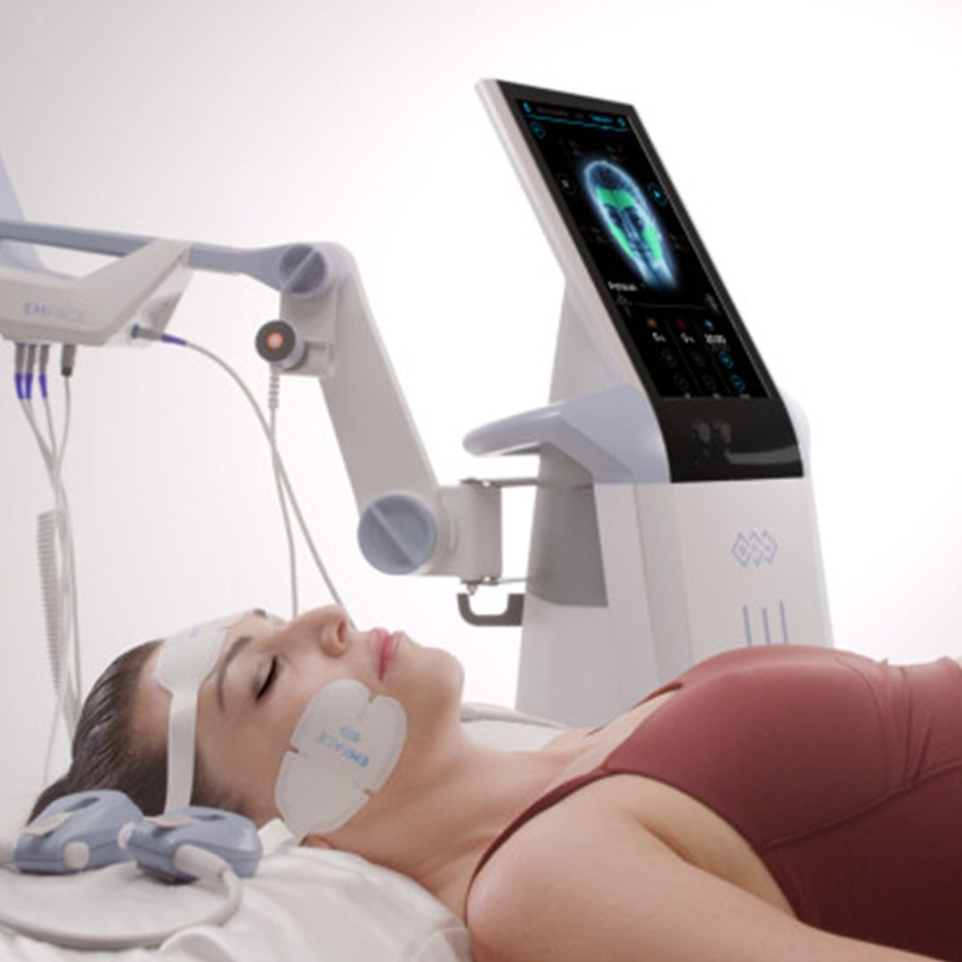 Woman lying down undergoing EMFACE facial lifting treatment using radiofrequency and HIFES technology