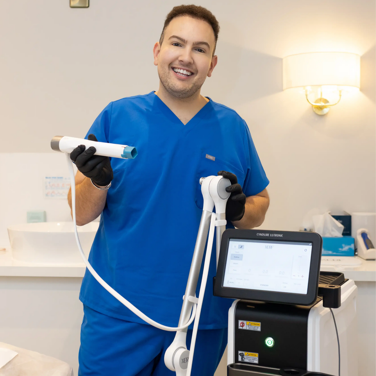 Dr Ahmed holding the new XERF Skin Tightening machine