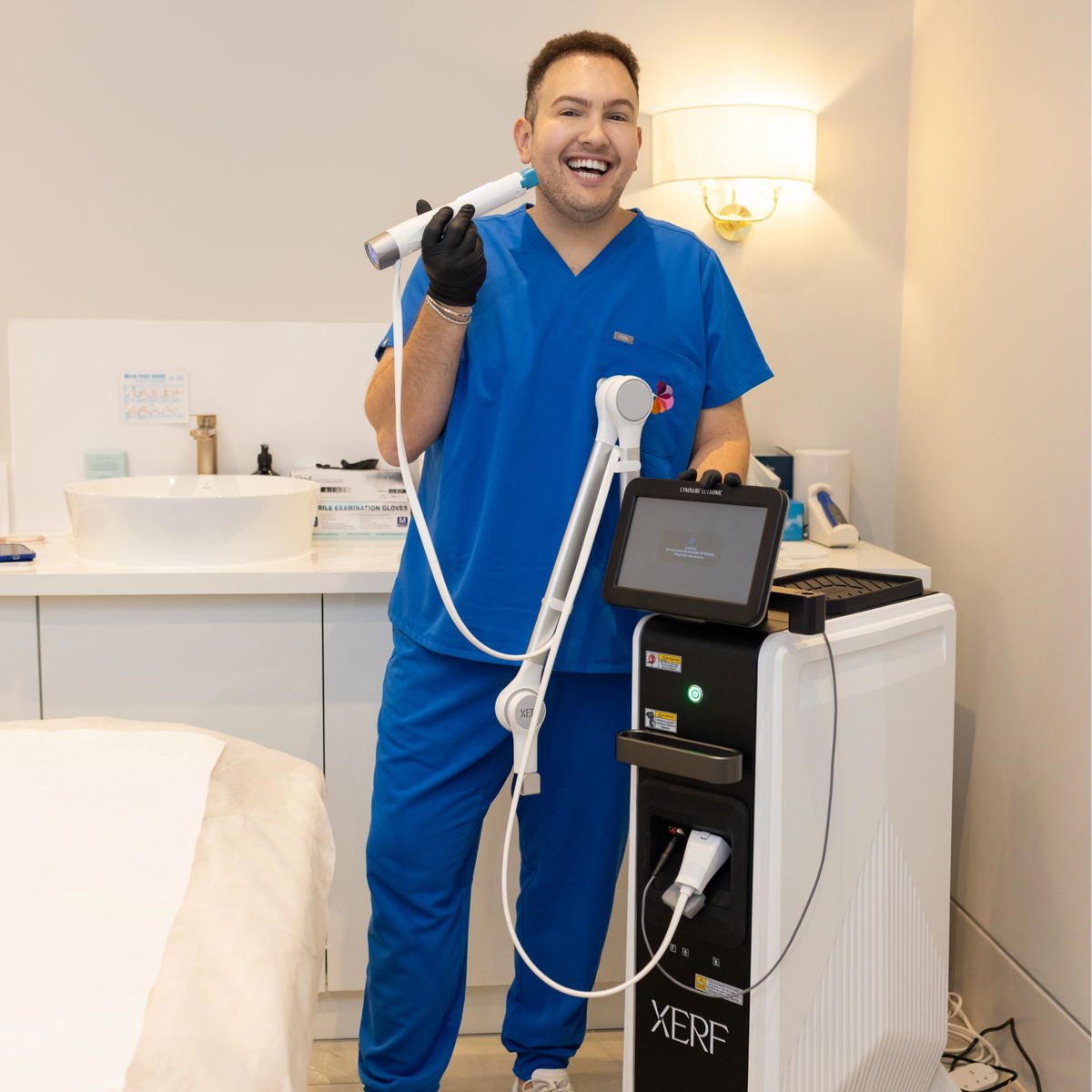 Dr Ahmed holding the new XERF Skin Tightening machine
